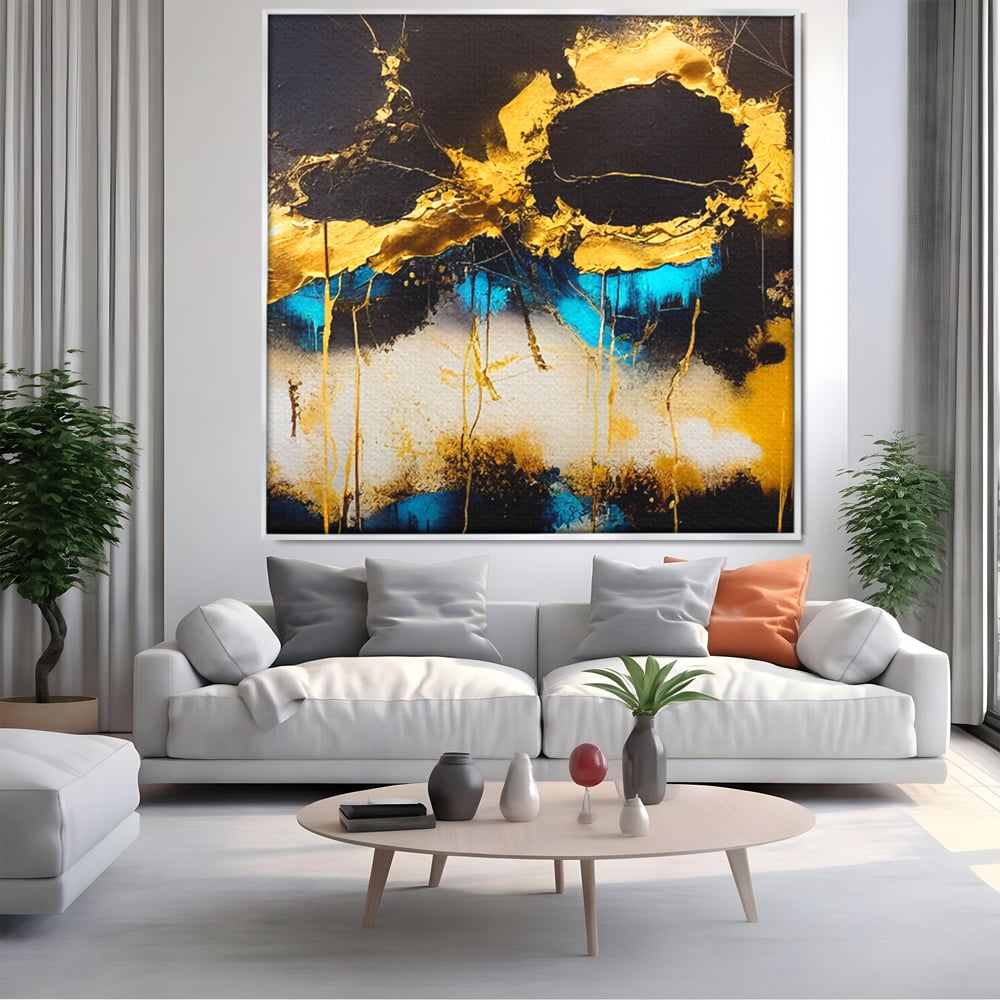 Tablou canvas cu pictura abstracta cu forme aurii si albastre, in rama de aluminiu argintiu, pe perete intr-un living